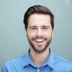 Portrait of a handsome young man with beard smiling Portrait of a handsome young man with beard smiling